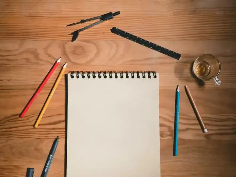 Drawing pad and crayons on table